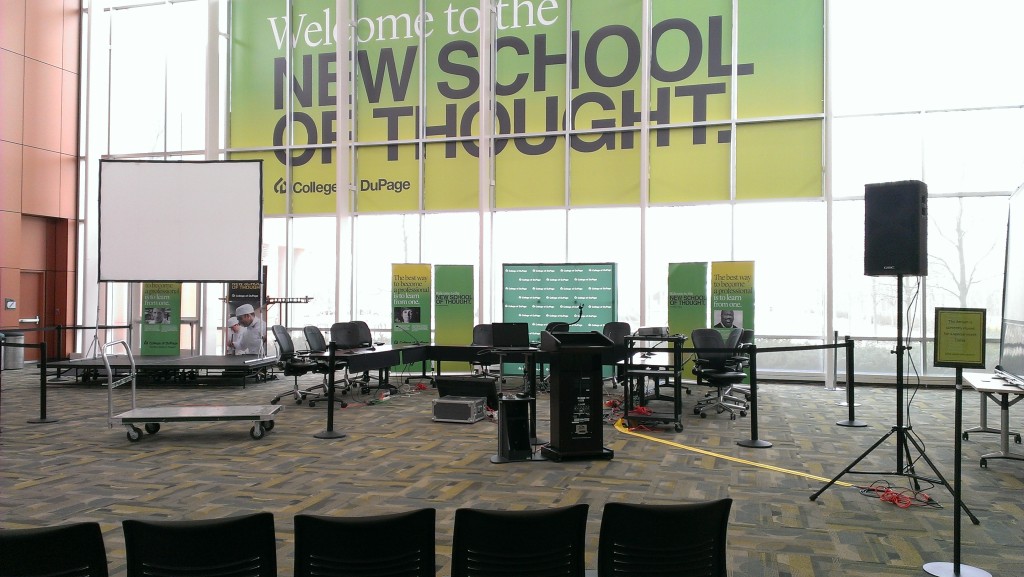 Seating for the trustees, behind a cordon, under enormous banner - Welcome to the New School of Thought